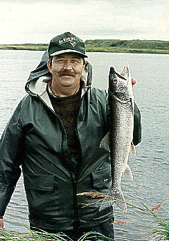 Marcel holds a lake trout