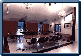 Meeting room arranged with tables.