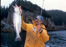 Doug Olander of Sport Fishing Magazine hefts a bright Silver caught on an ultra-lite outfit while fishing with Capt. Steve.