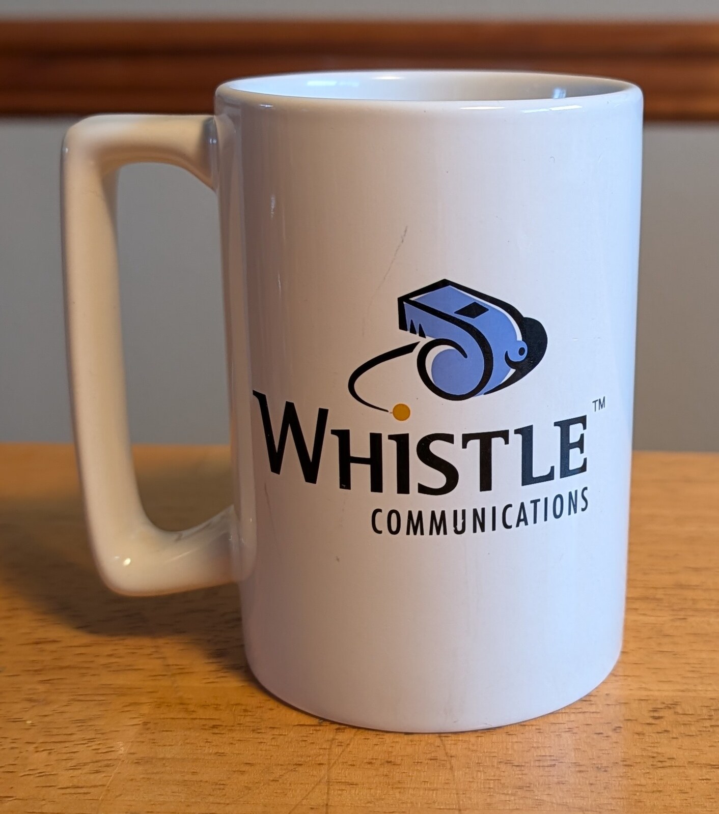 A Whistle mug from after IBM acquired Whistle, front: the Whistle Communications logo.