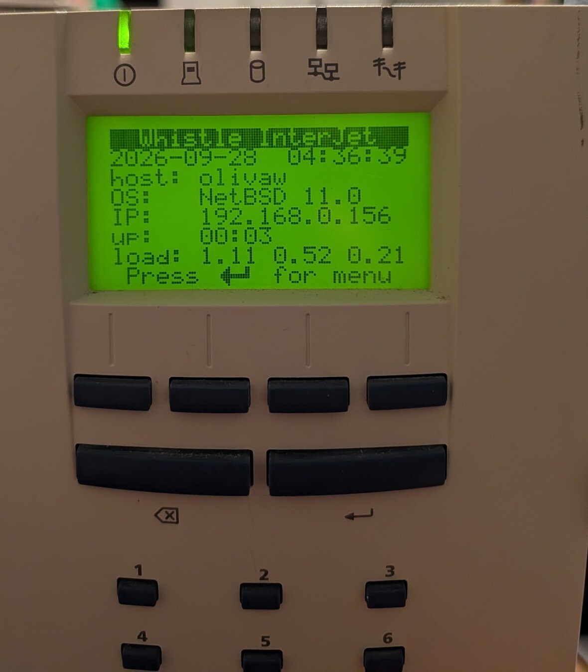 An InterJet 200 running NetBSD 11.0: the status screen of lcdd, our panel program, with host, OS, address, uptime and load.