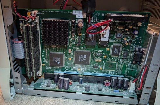 The InterJet mainboard in its chassis, side open: ALi chipset, memory modules at left.