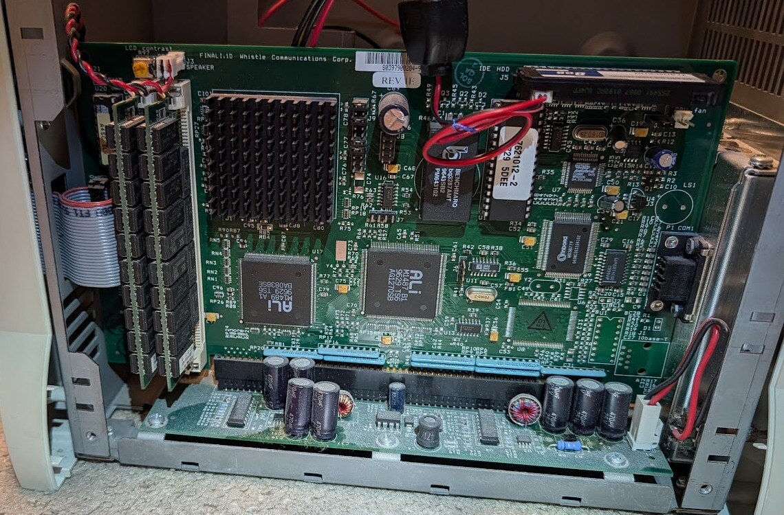 The InterJet mainboard in its chassis, side open: ALi chipset, memory modules at left.