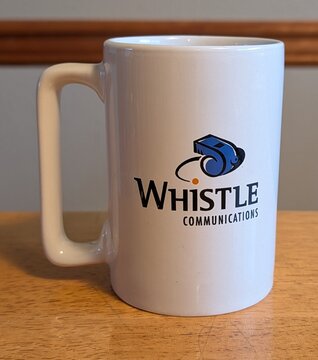 An original Whistle mug, front: the Whistle Communications logo.