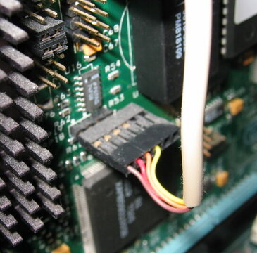 A keyboard header and cable on the mainboard.
