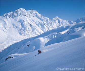 skier with byron headwall